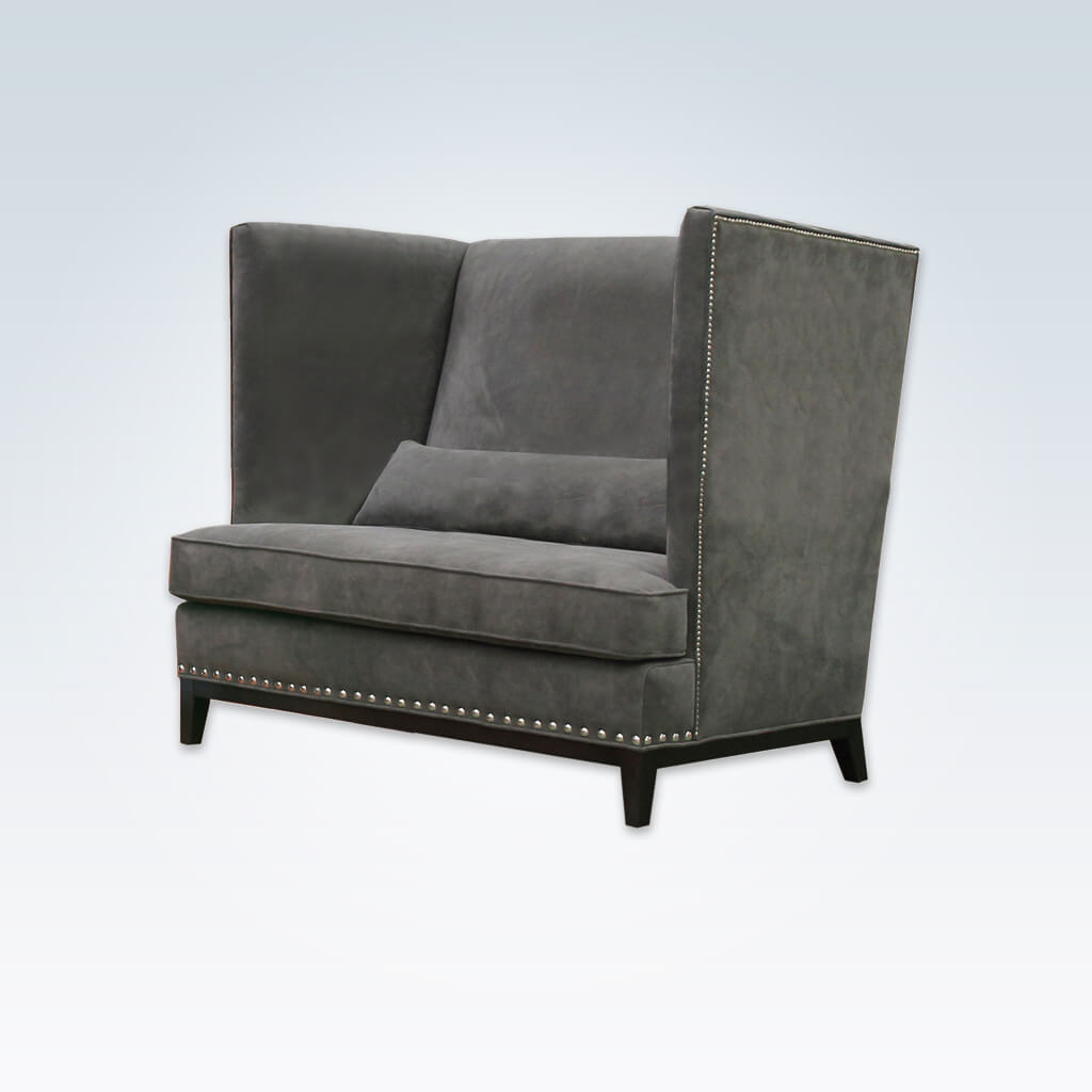 Aneto dark grey fabric accent chair with a show wood plinth and decorative studding 