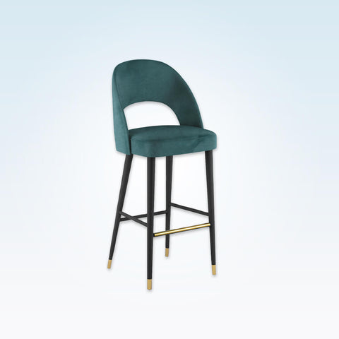 Forbes turquoise bar stool with large cut out to the backrest and conical wooden legs with metal feet