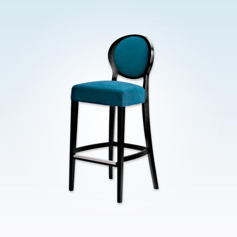 Suli dark blue bar stool with round backrest upholstered to the centre. Featuring tapered timber legs splayed to the rear and a metal trimmed kick plate