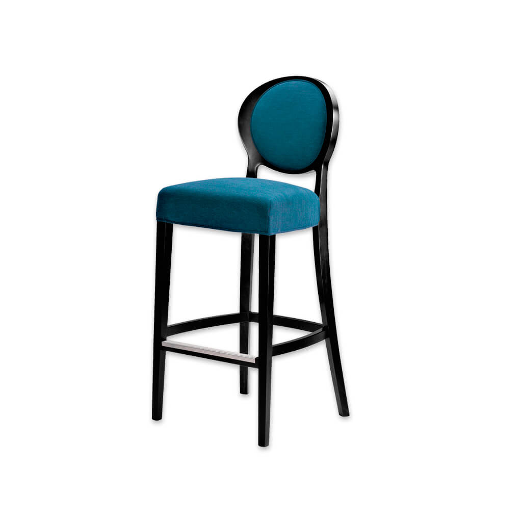 Suli dark blue bar stool with round backrest upholstered to the centre. Featuring tapered timber legs splayed to the rear and a metal trimmed kick plate - Designers Image