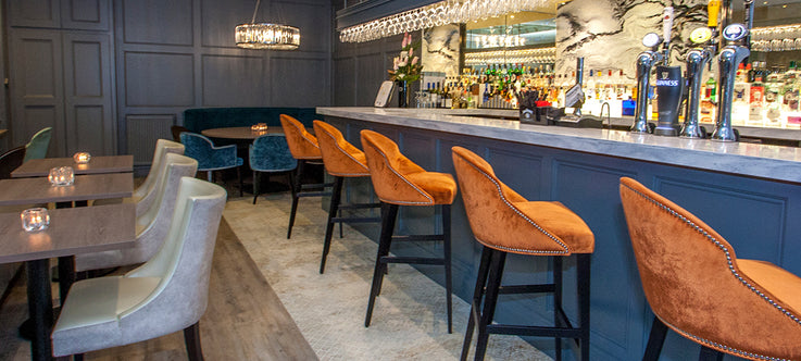 orange bar stools with stud detail