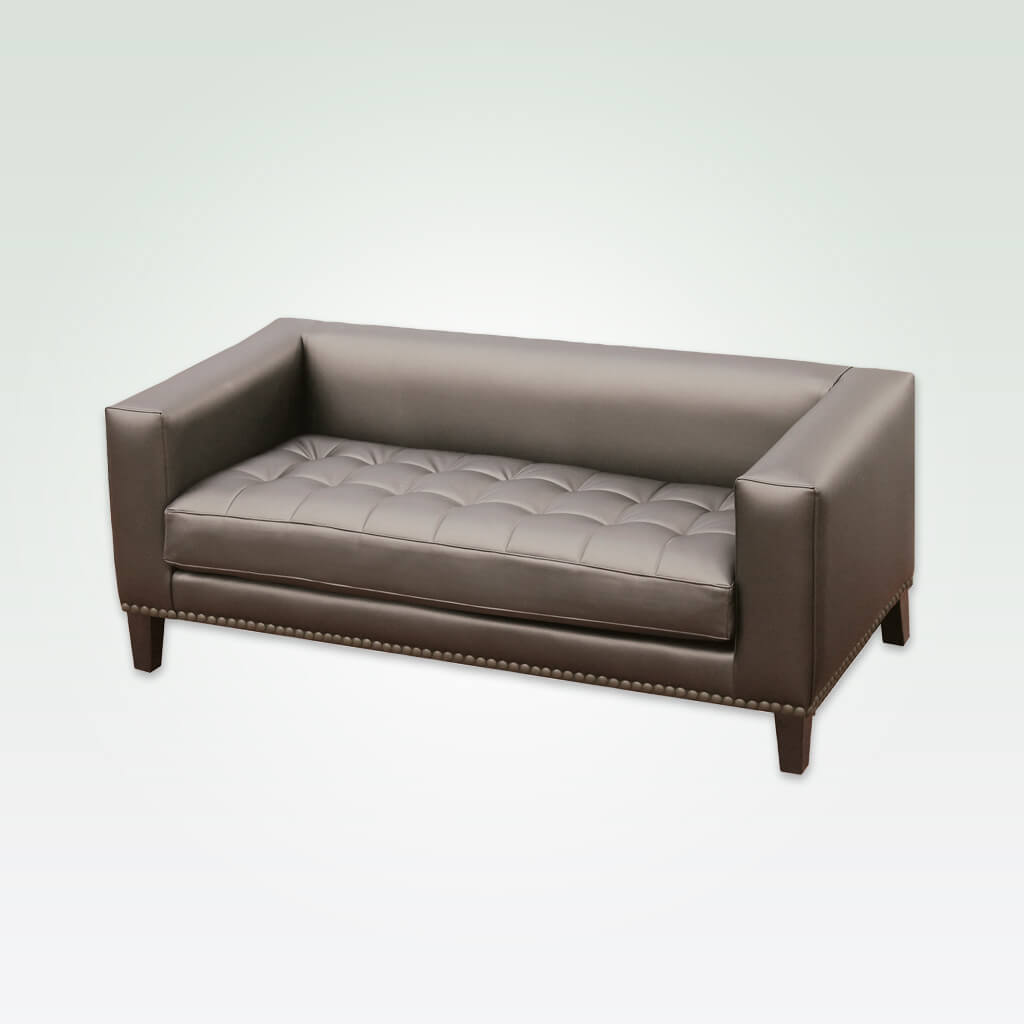 Blog brown studded sofa with square arms and back, decorative buttoning to the seat cushion
