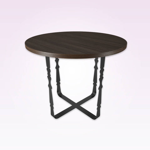 cyrus dining table with round wooden top and ornate metal cross base