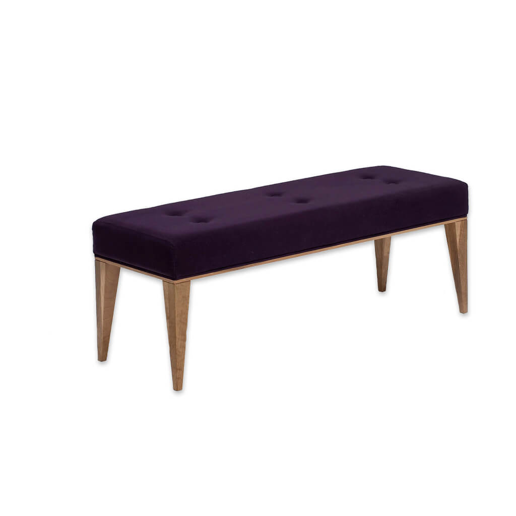 Margot dark purple ottoman with deep buttoning to the padded cushion and tapered gold legs - Designers Image
