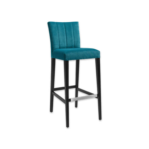 Sage blue bar stool with upholstered cushion featuring decorative stitching to the backrest and a wooden frame with metal trimmed kick plate