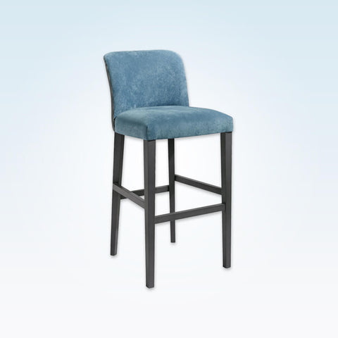 Tori baby blue bar stool upholstered in velvet with a dark wood frame and tapered legs